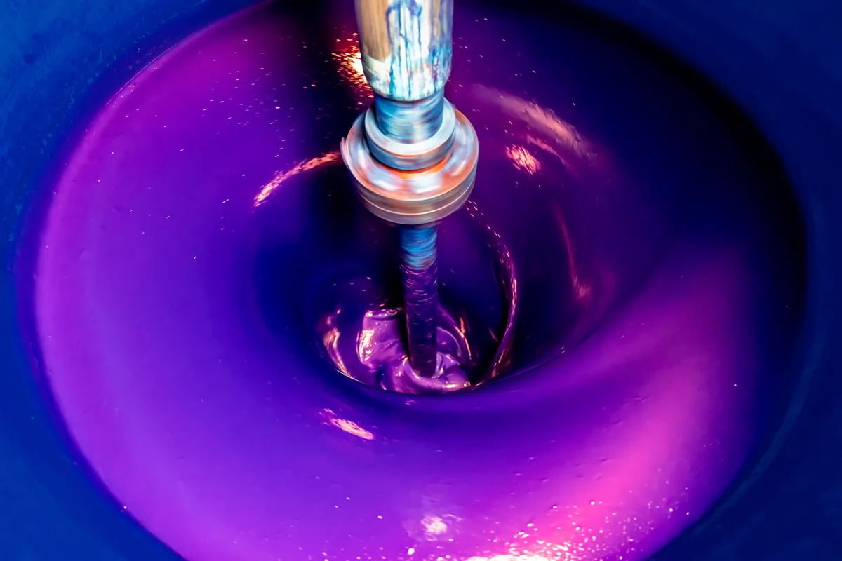 Violet pigmented paste being dispersed in an industrial mixer